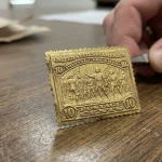 Close-up of a 22k gold replica United States postage stamp